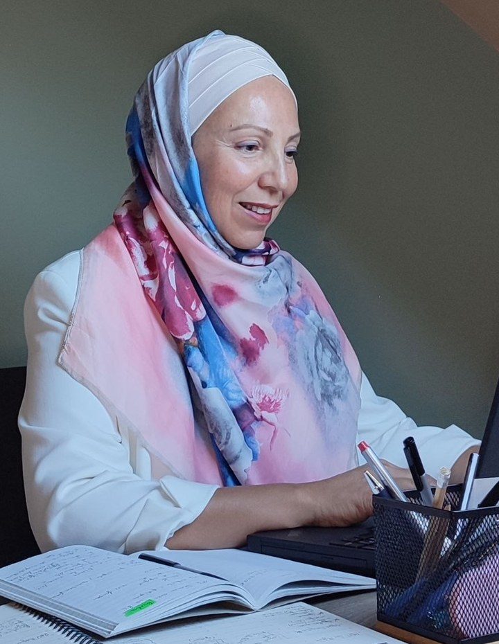 Souad Sedjai smiling at her desk